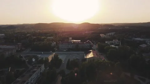 Smooth flight forward on a drone over an evening small town, sunset Vidéo 161824402