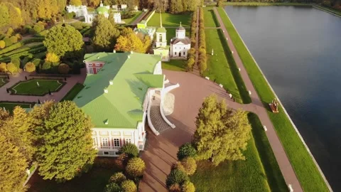 A smooth flight over a lake and a landscaped park on a sunny day Stock Footage 256813987