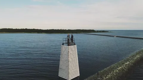 Smooth flight over the lake with a small lighthouse Video stock 161433725