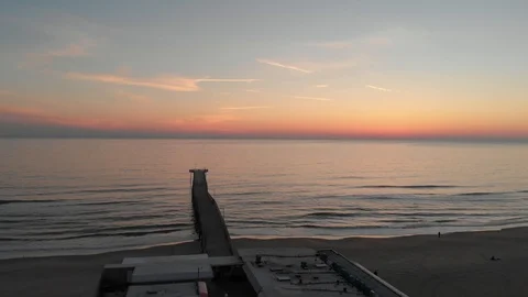Smooth flight over a pier at a beach Stock Footage 87526131