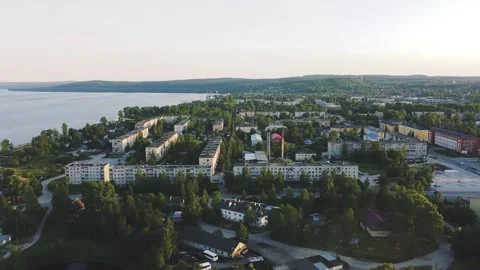 Smooth flight to the side on a drone over an evening small town, sunset Video stock 161824411