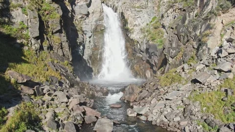 A smooth flight to the waterfall over the river and the big stones between the Stock Footage 269303128