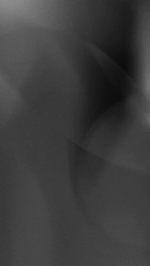 Smooth flowing black grey gradient motion creates a liquid abstract background 스톡 동영상 327372569