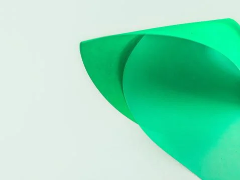 Smooth, folded green paper texture with ample copy space. Ideal for brandin.. Stock Photos