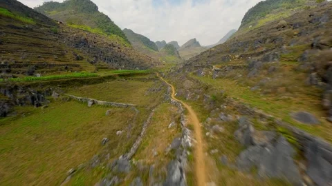 Smooth FPV drone flight over rocky mountain trail in Ha Giang highlands, Vietnam Stock Footage 306518297