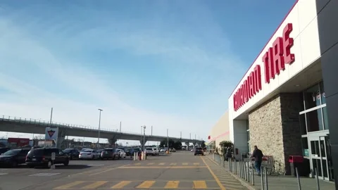 Smooth Gimbal Driving Tracking Shot of Canadian Tire in Kirkland Stock Footage 224779068