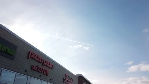Smooth Gimbal Driving Tracking Shot of Pizza Pizza Store Stock Footage 224779528