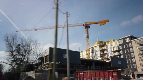 Smooth Gimbal Driving Tracking Shot of New Condominium Construction Stock Footage 224779659