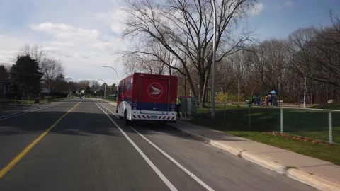 Smooth Gimbal Driving Tracking Shot of Post Canada Delivery Truck Stock Footage 224779672