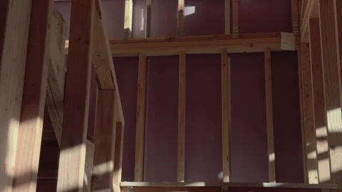 Smooth glide past framed staircase inside unfinished residential construction Vidéo 332793861