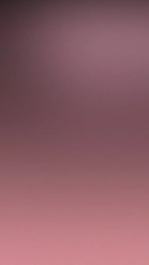 Smooth gradient backdrop with warm pink to purple tones and subtle texture. 库存影片 309856200