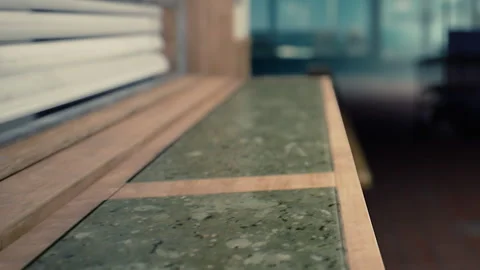 Smooth Green Stone Surface Awaits Creative Ideas in a Modern Workspace Stock Footage 344821444