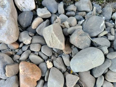 Smooth grey and brown river rocks perfect for naturethemed designs, backgrounds, Stock Photos