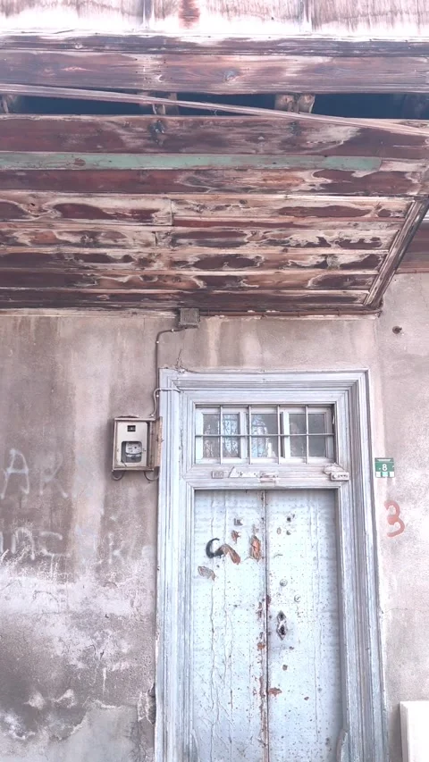 Smooth horizontal camera pan from left to right revealing graffiti on a decaying Vídeos de archivo 334659948
