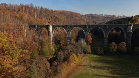 Smooth Horizontal Drone Flight Away from Viaduct in Autumn Valley Stock Footage 320839915