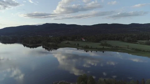 Smooth lake in the coutryside reflecting the sky aerial Stock Footage 113340111
