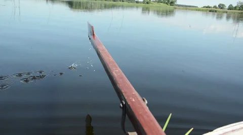 Smooth lake surface disturb the touch paddle making circles Stock Footage 39028361