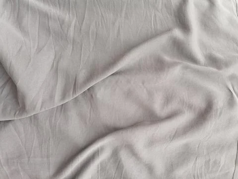 Smooth Light Beige Fabric Texture with Elegant Draped Folds Stock-Fotos