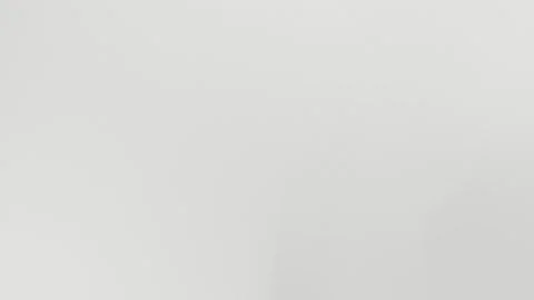 Smooth light gray seamless loop background with subtle gradient and fine Stock Footage 309955716