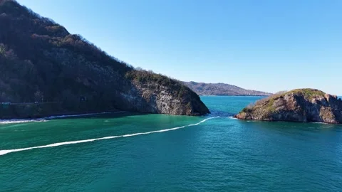 Smooth Low Aerial Flight Toward Island Over Calm Blue Water Stock Footage 342813506
