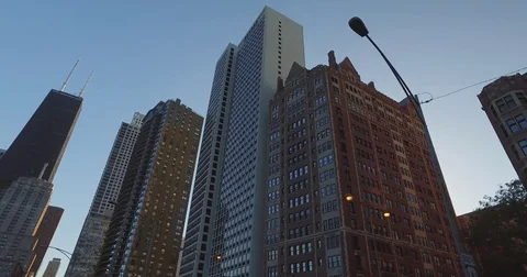 Smooth, low angle tracking shot, taken from a car, as it rides down the Chicago Stock Footage 81876487
