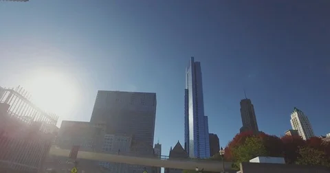 Smooth, low angle tracking shot, taken from a car, as it rides down the Chicago Stock Footage 81877256