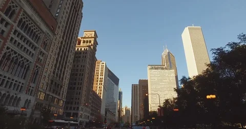 Smooth, low angle tracking shot, taken from a car, as it rides down the Chicago Stock Footage 81877552