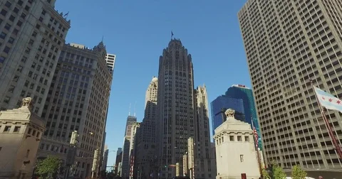Smooth, low angle tracking shot, taken from a car, as it rides down the Chicago Stock Footage 81877921