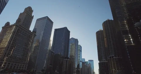 Smooth, low angle tracking shot, taken from a car, as it rides down the Chicago Stock Footage 81879344