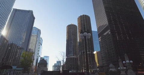 Smooth, low angle tracking shot, taken from a car, as it rides down the Chicago Stock Footage 81879640