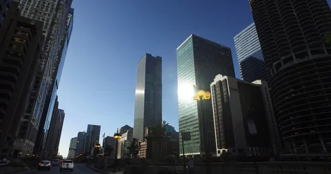 Smooth, low angle tracking shot, taken from a car, as it rides down the Chicago Stock Footage 81879957