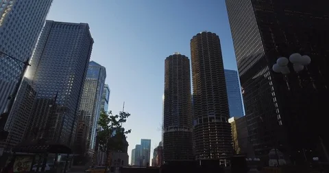 Smooth, low angle tracking shot, taken from a car, as it rides down the Chicago Stock Footage 81880447
