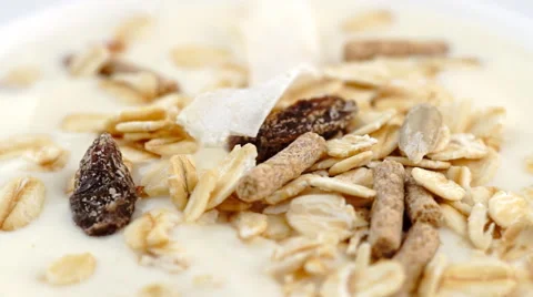 Smooth low-fat yogurt with granola, oats and muesli rotating in slow motion Stock Footage 43743053