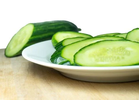 A smooth, medium-sized cucumber cut into slices. Cucumber on a plate. Vegetab Stock Photos
