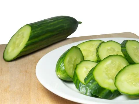 A smooth, medium-sized cucumber cut into slices. Cucumber on a cutting board. Stock Photos