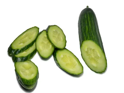 Smooth medium-sized cucumber on a white background. Cucumber slices, isolate. Stock Photos