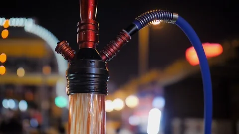 Smooth motion: shisha with pipe standing on the table in the hookah outdoor bar Stock Footage 111076707