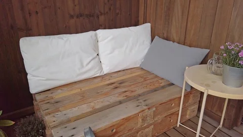 Smooth motion shot of pallet couch on balcony. Stock Footage 109379532