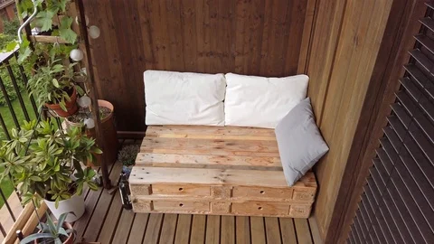 Smooth motion shot of pallet couch on balcony. Stock Footage 109380447