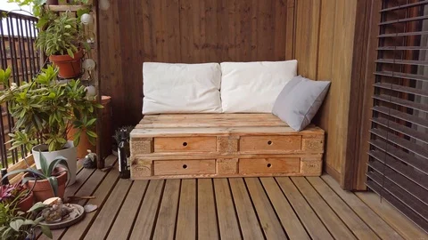 Smooth motion shot of pallet couch on balcony. Stock Footage 109380556