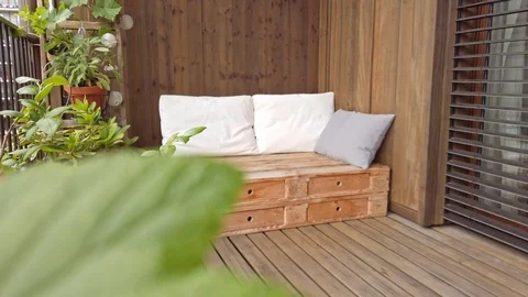Smooth motion shot of pallet couch on balcony. Stock Footage 109380636