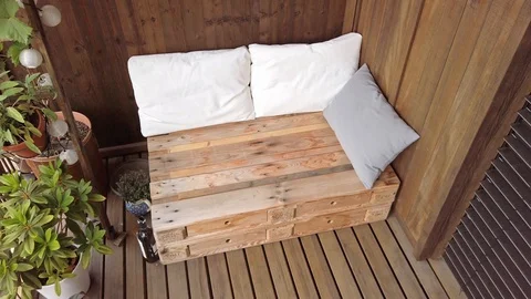 Smooth motion shot of pallet couch on balcony. Stock Footage 109381003