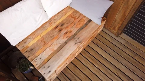 Smooth motion shot of pallet couch on balcony. Stock Footage 109381212