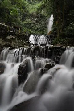 The smooth motion of a stepped waterfall in the forest Stock Photos