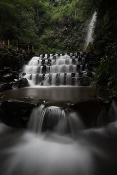 The smooth motion of a stepped waterfall in the forest Stock Photos