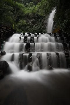 The smooth motion of a stepped waterfall in the forest Stock Photos