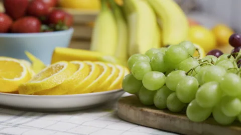 Smooth movement across beautiful, fresh, cut fruit on kitchen counter - closeup Stock Footage 341242428