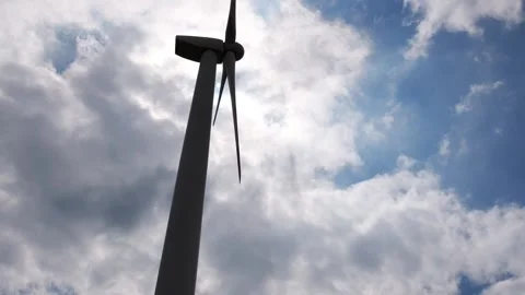 Smooth movement of blades of a huge wind turbine Stock Footage 315414895