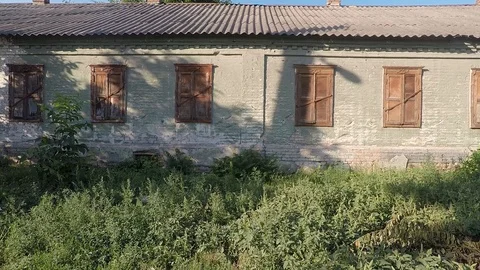 Smooth movement of the camera along the old house with wooden shutters closed Stock Footage 113171774