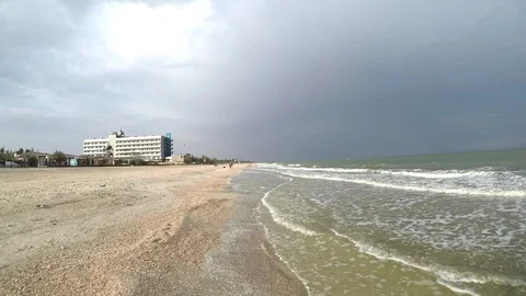 Smooth movement of the camera along the surf line sea with small waves against Stock Footage 122634786